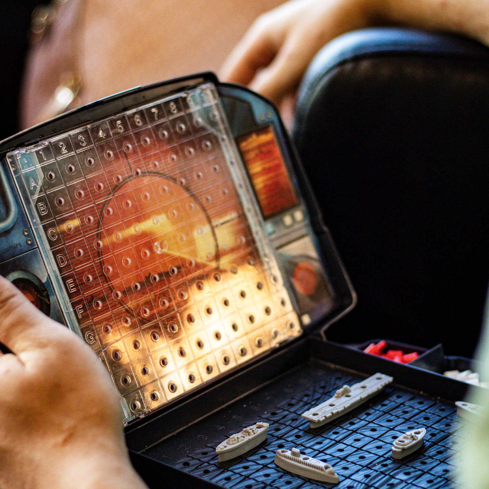 A game of Battleship in progress at a table inside the Blue Cafe.