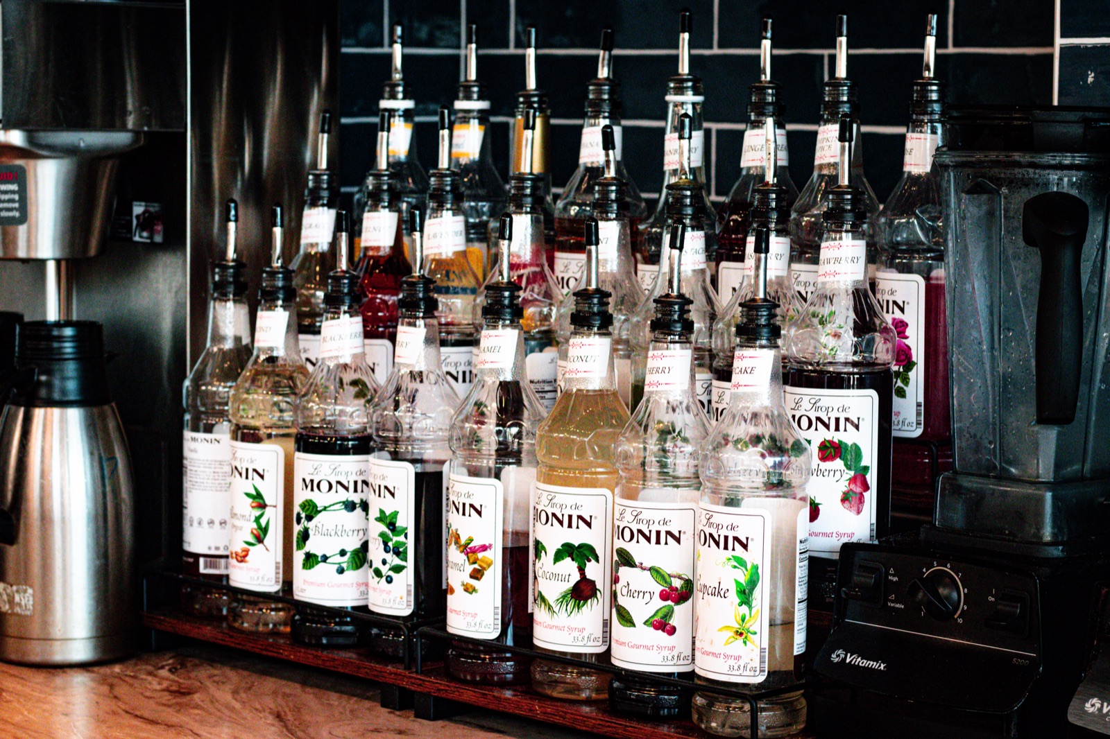 Flavor syrups lined up behind the Blue Café counter.